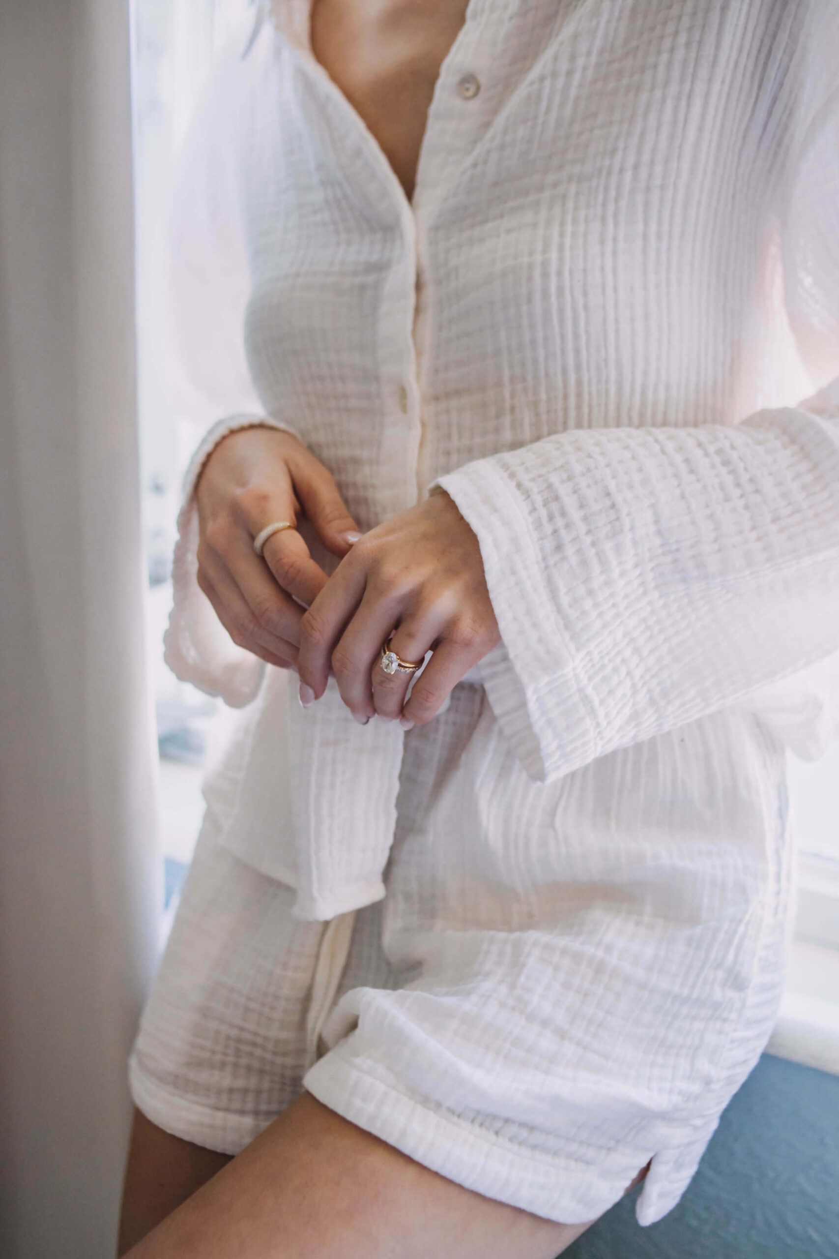 Woman waking up anxious and taking a quiet morning pause by a window.