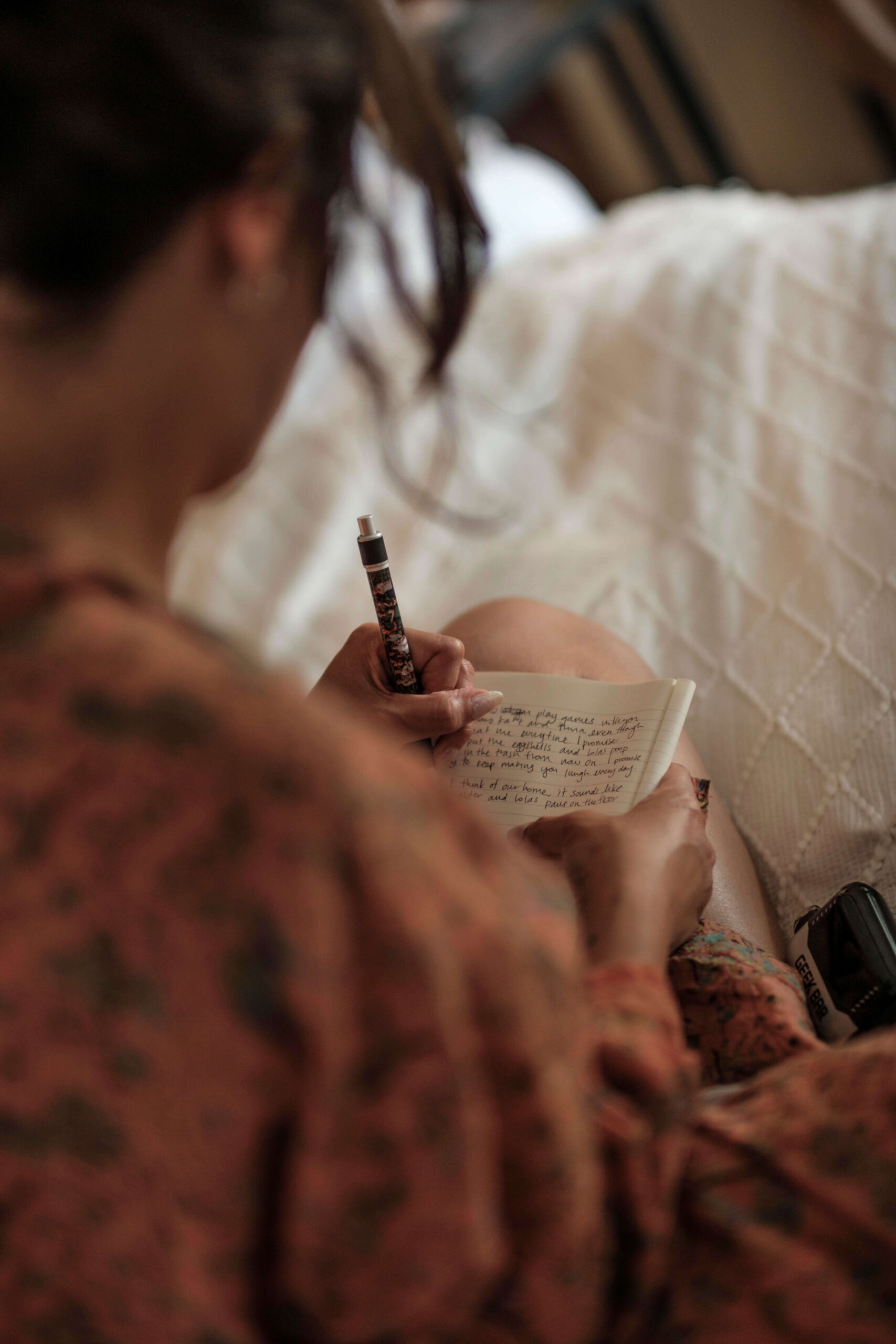Woman relaxing in bed journaling before sleep